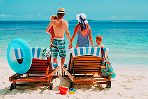 family with 2 young children at the beach
